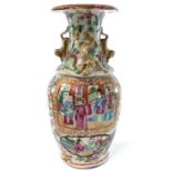 A Chinese Canton porcelain vase, 19th century, with numerous panels enclosing figures, height 23cm.