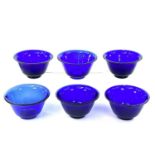 Six Peking blue glass bowls, largest height 6cm, diameter 10.5cm.