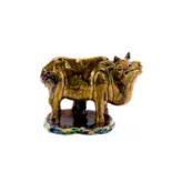 A Chinese sancai glazed pottery model of a water buffalo, circa 1900, in the form of a