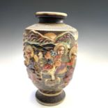 A Japanese Satsuma pottery vase, circa 1920's, decorated on relief with figures and trees in a