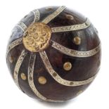 An Indian wooden ball, early 20th century, applied with white metal spiral decoration, brass