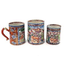 A set of three Chinese graduated porcelain mandarin palette mugs, 18th century, the cylindrical body