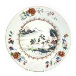 A Chinese famille rose porcelain charger, Qianlong Period, painted with a river scene to the centre,