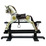 A Tri-ang carved and painted wood rocking horse, with dapple markings and leather saddle, on an