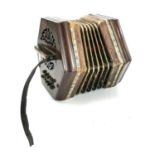 An early 20th century twenty button five fold bellow concertina with rosewood pierced fretwork