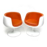 Eero Aarnio (Finnish b.1932), A pair of Cognac Chairs, in white lacquered fibreglass, with orange