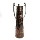 An Art Nouveau copper three handle vase with chased border and typical repousse stylised flowers