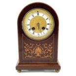 An Edwardian mahogany and inlaid dome top mantel clock, the gilt brass face with cream chapter ring,