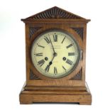 An oak mantel clock, German, circa 1900, the white painted dial inscribed John Elkan, Liverpool