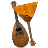 A Stridente mandolin with mother of pearl inlay and makers label, length 60cm, together with a