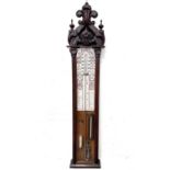 A Victorian Admiral Fitzroy barometer, with printed scales, contained in an oak case, with ornate