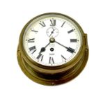 A Sestral ship's brass cased bulkhead clock, the dial stamped Olsen's Grimsby, diameter 20.5cm.