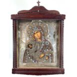 A Russian icon of the Mother of God, the silver finished oklad with a jewelled and embroidered mount