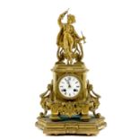 A late 19th century French gilt spelter mantel clock, surmounted by a figure of a musician, the