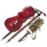 Vintage Mountaineering equipment, comprising two ice axes, a pair of crampons, a rope and a