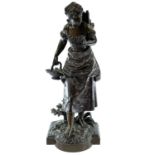 A bronze figure of a bare-foot farm girl, circa 1900, carrying a flower basket in her hand and