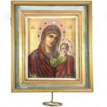 A Russian icon, painted with the Mother of God, inscribed to verso, contained in a glazed walnut