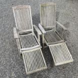 A pair of teak folding garden steamer chairs with detachable footrests,There is general wear and