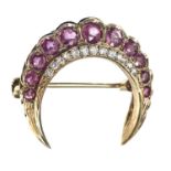 A modern 9ct gold diamond and ruby crescent brooch,