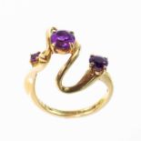 A Bernard Instone 9ct amethyst set three stone ring.