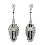 A pair of Art Deco style white metal white stone set pendant stud earrings.