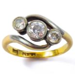 An 18ct gold three stone diamond cross-over ring,