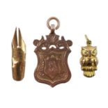 A 9ct rose gold shield fob, a 9ct gold owl charm and a 14ct pen nib.