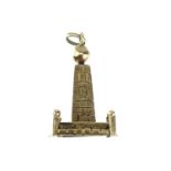 An 18ct gold charm in the form of an obelisk.