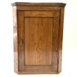 A George III oak hanging corner cupboard.