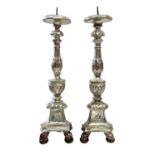 A pair of Italian silvered carved wood candle stands, circa 1700-1750.