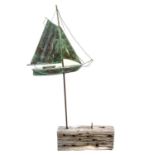 A copper weather vane in the form of a sailing boat,