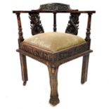 A Victorian carved oak corner armchair.