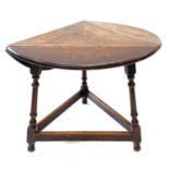 An oak drop leaf occasional table, early 20th century, of triangular form.