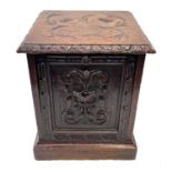 A Victorian carved oak coal box.