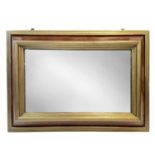 An 18th century style walnut and gilt framed wall mirror.