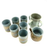 Alan Brough, A set of six cylindrical beakers, with speckled blue decoration, impressed seal