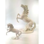 An Italian pottery lamp base, modelled in the white as a rearing horse, lacks all fittings, height
