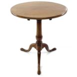 A walnut circular tripod table, 19th century, with a tilt top and turned pillar, height 67cm,