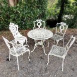 A cast metal garden table and five chairs in the Victorian style. Table height 69cm diameter 80cm