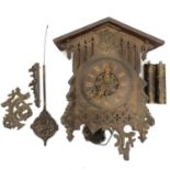 A Swiss Black Forest oak cuckoo wall clock, circa 1920, with Gothic pierced and applied tracery,