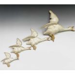 A set of four Royal Dux flying geese, printed mark verso, the largest 42cm.Largest duck has repair