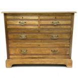 An Edwardian walnut chest of two short and two long drawers, on bracket feet, formerly a dressing