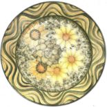 Adrian Brough, A studio pottery platter, with flower painted decoration within a waved border,