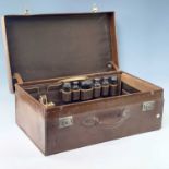 A late Victorian tan leather vanity case with a fitted interior including six silver topped toilet