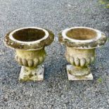 A pair of reconstituted stone garden urns of campana form, height 59cm diameter 63cm