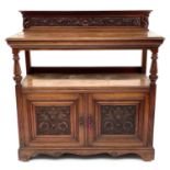 A late Victorian walnut buffet, with carved raised back and two carved doors below, height 125cm,