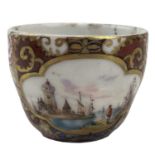 A Meissen miniature cup, 19th century, painted in the 18th century style with a quayside scene,
