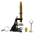A brass and painted metal microscope, circa 1900, with additional lens and viewer, height 39cm, in a