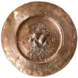 A copper charger, possibly Newlyn, repousse decorated with a galleon to the centre, with attached