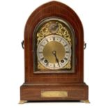 An early 20th century bracket clock by Winterhalder & Hofmeier with arched brass dial in a lancet